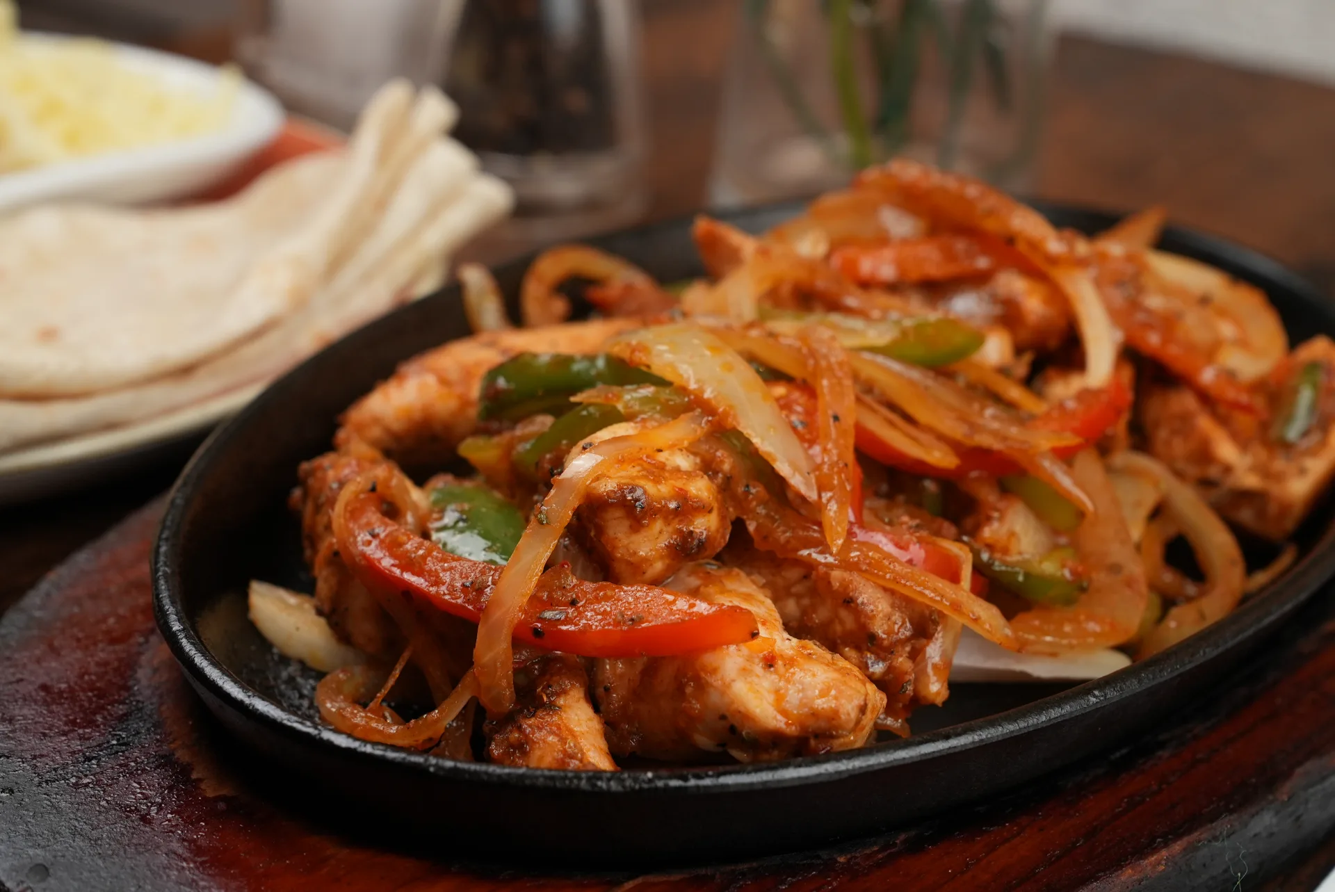 Sizzling chicken fajitas on cast iron skillet at Frida Camden — most-ordered dish since 2011, Camden Town London