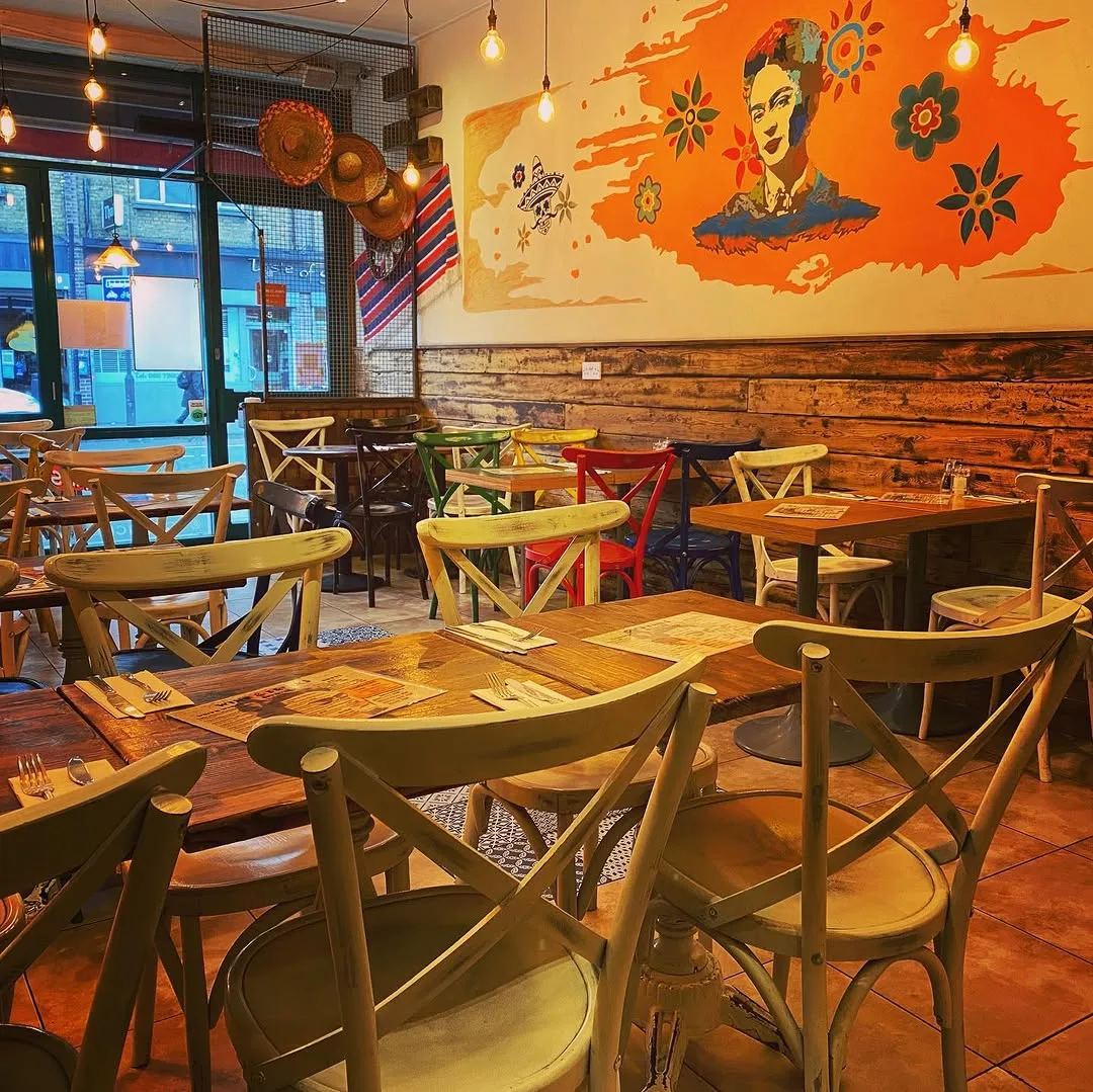 Frida Camden interior with Frida Kahlo mural and empty tables — Mexican restaurant venue Camden High Street London